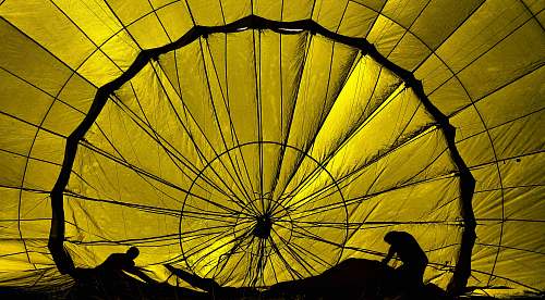 parachute silhouette of two persons working silhouette