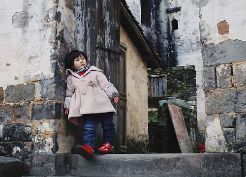  girl leaning on concrete wall 