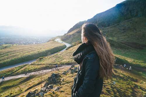  woman standing on hill 