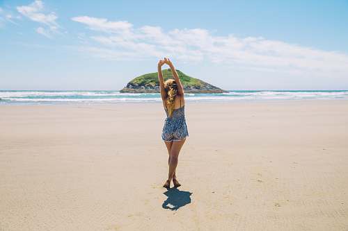 ocean woman on seashore near island under blue sky sea
