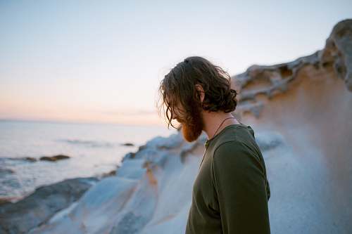 man man in green shirt on seaside male