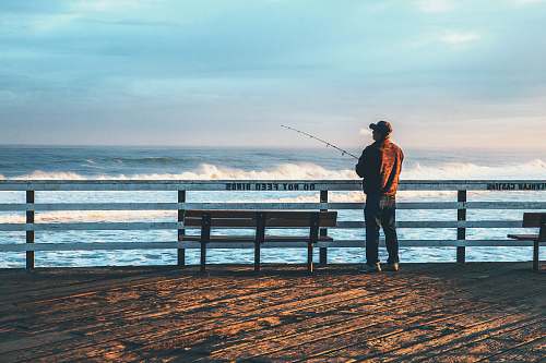 human man fishing on seaside people