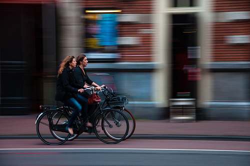 bicycle time lapse photography of two person riding bicycle transportation