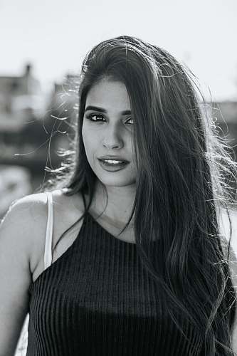 human grayscale photo of woman in cami-strap top people