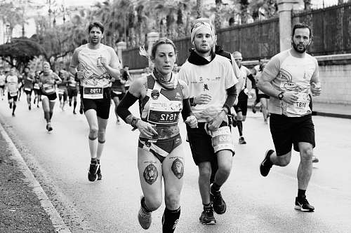 person grayscale photography of jogging people people