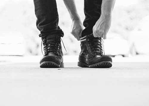 boot person wearing black leather lace-up boots clothing