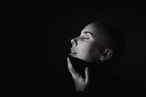 portrait woman with hand on chin gray scale photography face