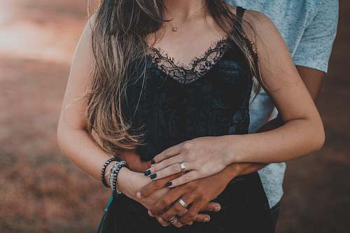 person man behind woman wearing black lace top human