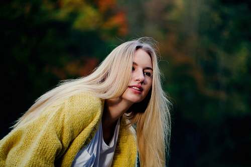 blonde woman wearing yellow cardigan woman