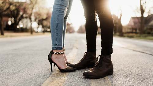shoe worm's eye view photography of man and woman facing each other boot