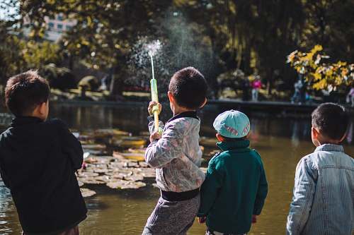 people boy playing near the river person
