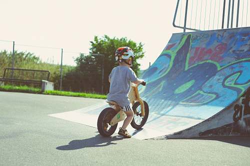 person boy riding brown bike people