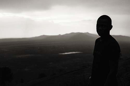 people boy standing on bare hill during foggy day person