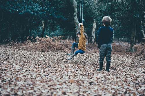 people boy standing on dried leaves person