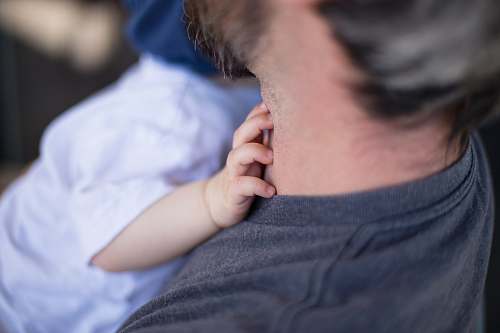 people close-up photo of man carrying baby person