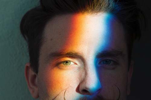 person closeup photo of man's face with light reflections people