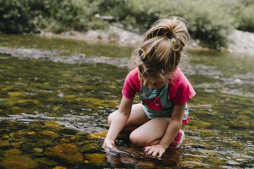 people girl playing on body of water person