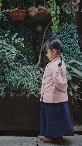 people girl standing in front of garden person