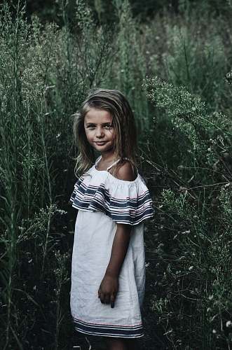 people girl standing near tall grasses person