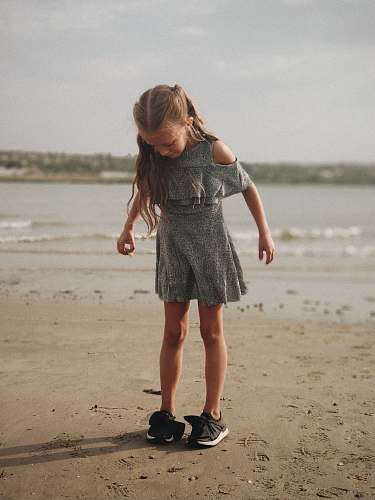 people girl wearing gray dress standing on shore person