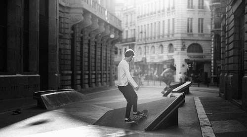 people grayscale photography of man skateboarding black-and-white