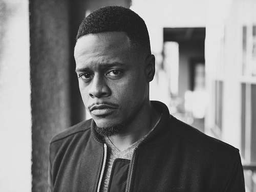 black-and-white grayscale photography of man wearing zip-up top portrait