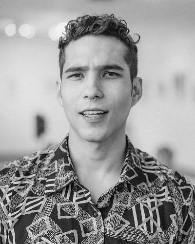 black-and-white greyscale photo of a man wearing gray collared shirt portrait