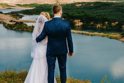 people groom and bride standing on a cliff person