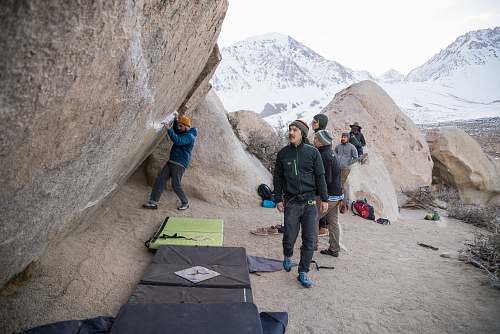 people group of men standing near rock formation person