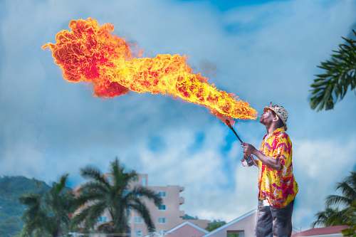 people man blowing gas to make fire tree