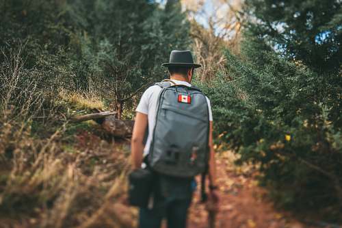 people man carrying gray backpack person
