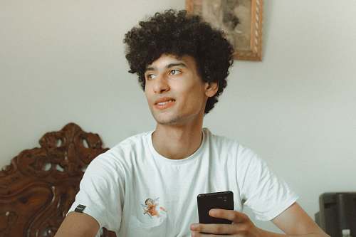 people man holding black smartphone person