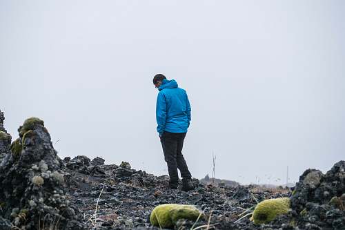 people man in blue jacket hands on pocket person