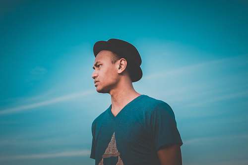 people man in green V-neck shirt looking sideways during daytime person