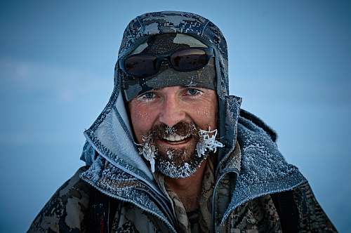 person man in grey and black jacket with frost bites people