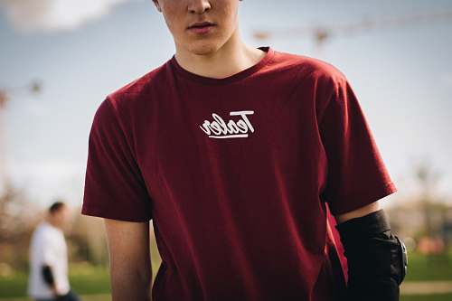people man in red crew-neck shirt under sunny sky person