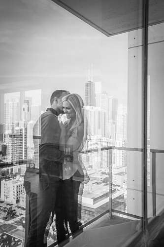 black-and-white man kissing woman grey
