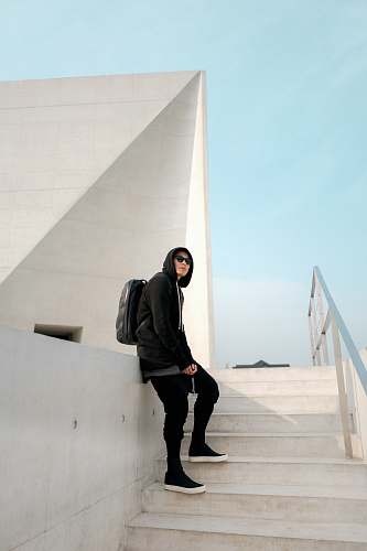 people man leaning on white deck while standing in stairway person