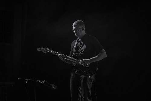 people man playing guitar black-and-white
