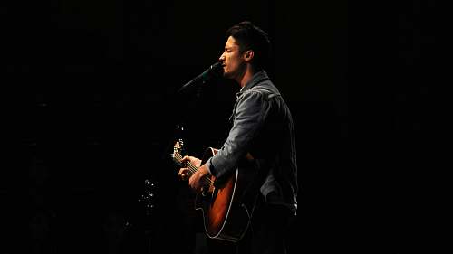guitar man playing guitar while singing music