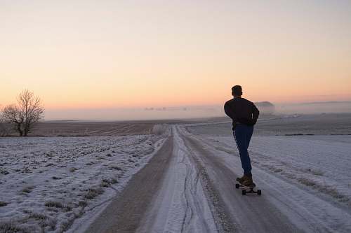 people man playing skateboard on road person