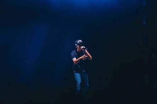 people man singing inside dim room person