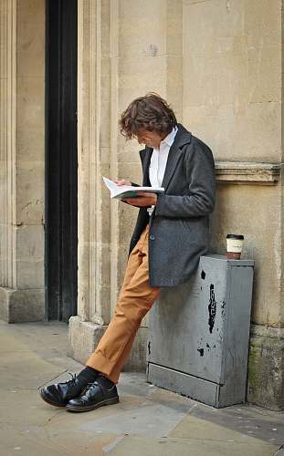people man sitting beside cup of coffee person