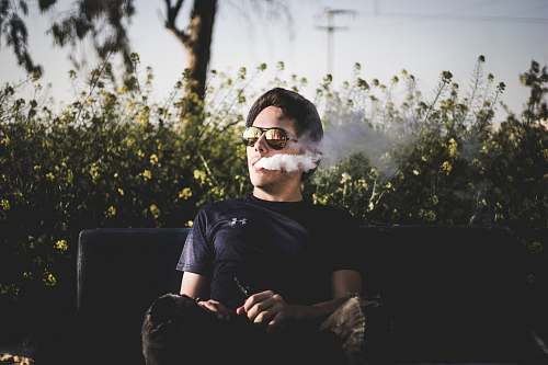 people man sitting on bench and smoking person