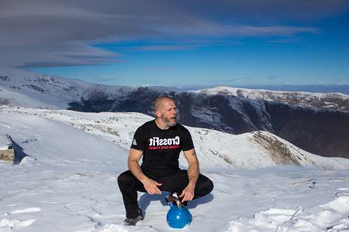 people man sitting on snow person