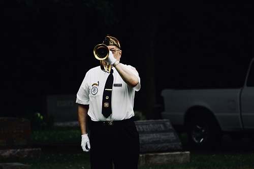 people man standing and blowing trumpet person