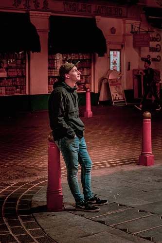 people man standing at road during night time person