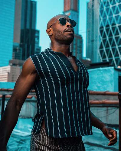 people man standing beside buildings person