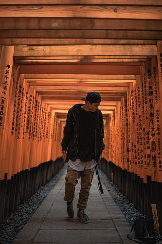 people man standing between torii gate person