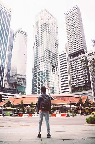 person man standing in front of building people